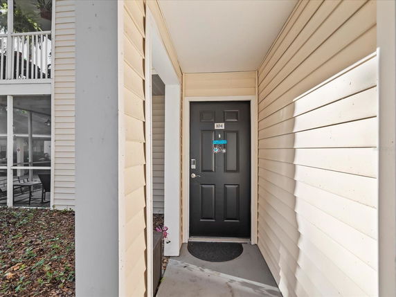 Front view of an apartment entrance with a black door.