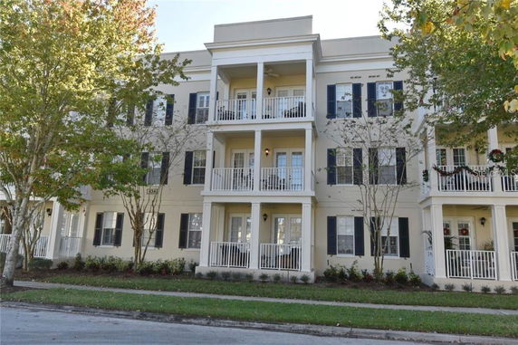 Front view of a multi-story residential building with balconies.