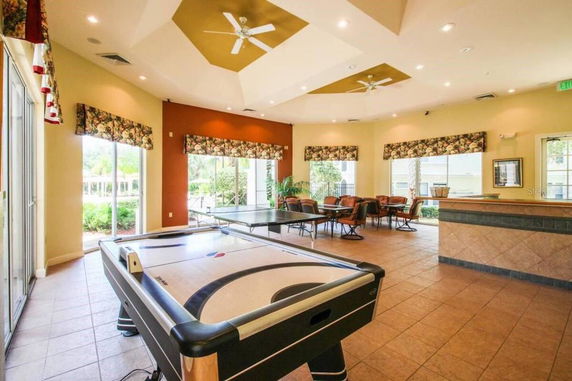 Indoor recreation area with game tables and seating.
