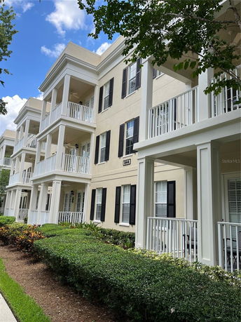 Front view of a multi-level residential building with balconies.
