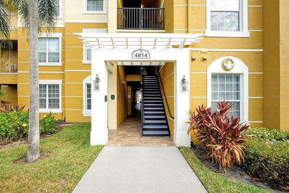 Front view of a multi-story building with a staircase entrance.