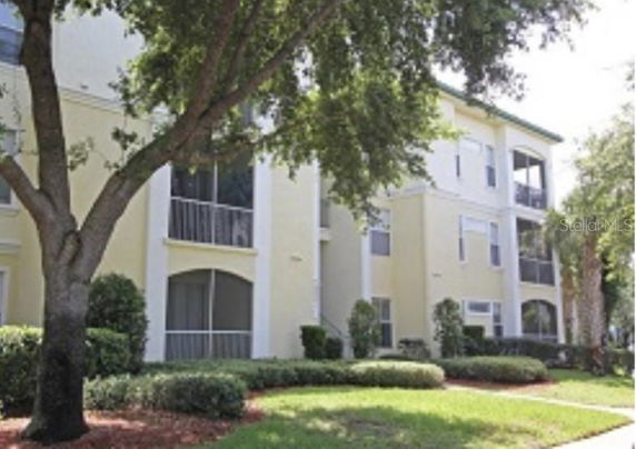 Front view of a multi-story apartment building with balconies.