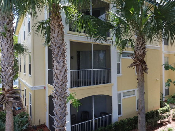 Front view of a multi-story residential building with screened balconies.