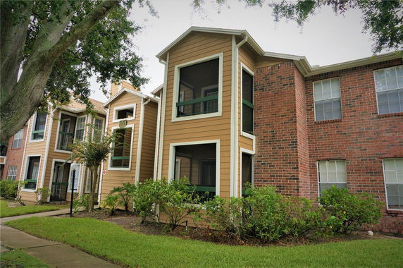 Front view of a two-story building with a combination of brick and wood siding.