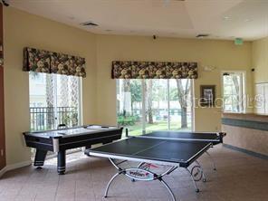 Indoor recreation area with a ping pong table and air hockey table.
