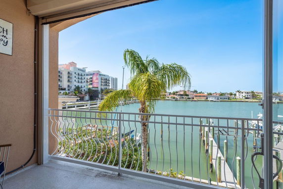 View of waterfront and buildings from a balcony.