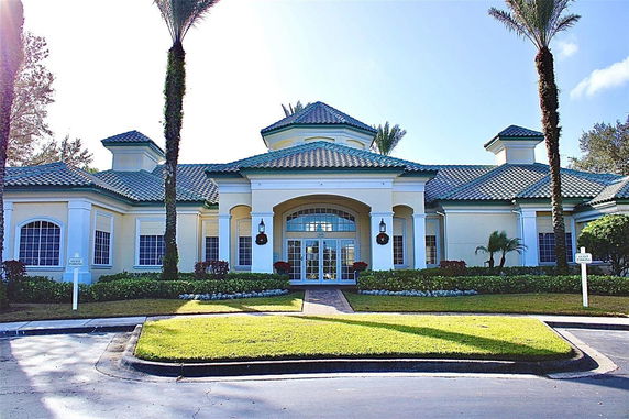 Front view of a building with a tiled roof and columns.