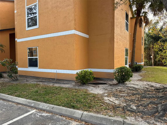 Side view of a building with orange walls and white trim.