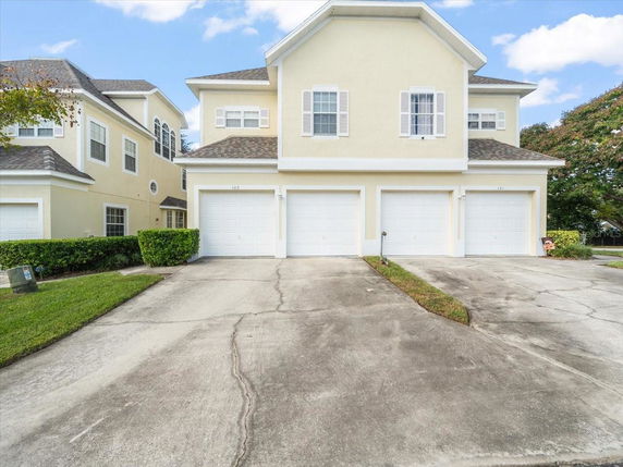 Front view of a two-story house with three garages.