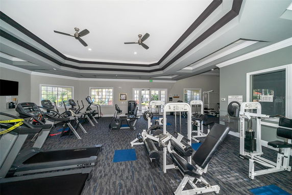 Indoor gym area with various exercise equipment and treadmills.