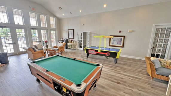 Recreation room with a pool table and air hockey table.
