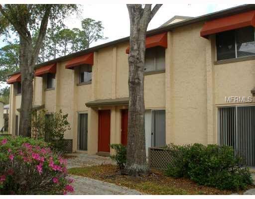 Front view of a two-story residential building with multiple entrances.