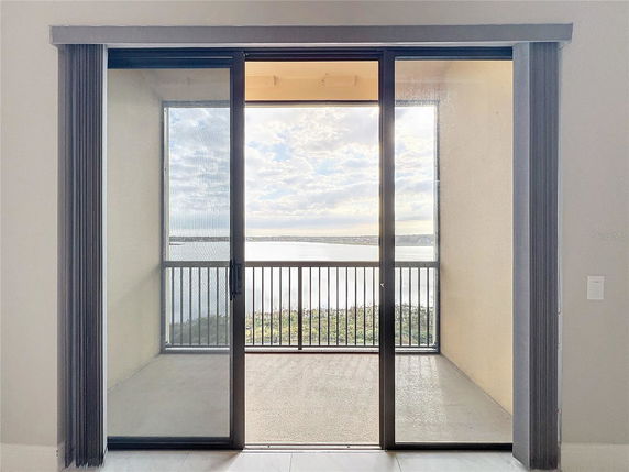 View through sliding glass doors overlooking a balcony and landscape.