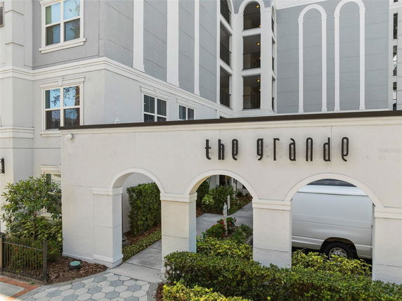 Front view of a multi-story building with arched entrance labeled 'The Grande'.