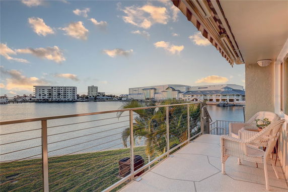 Balcony view overlooking water and distant buildings.