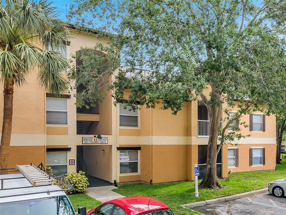 Front view of a multi-story apartment building with a stairway entrance.