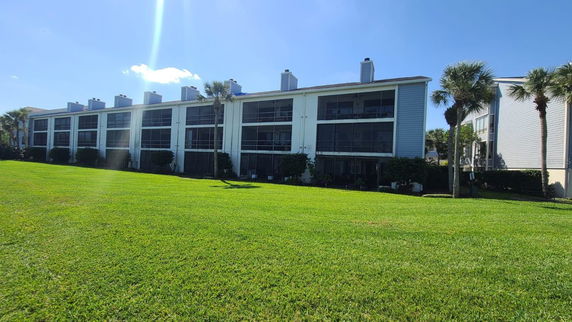 Front view of a multi-story residential building with balconies.