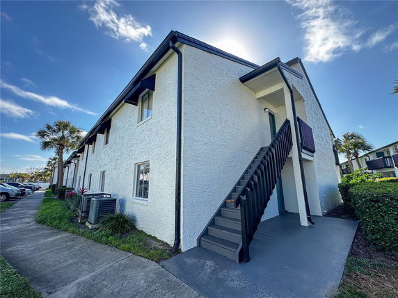 Front view of a two-story building with an exterior staircase.