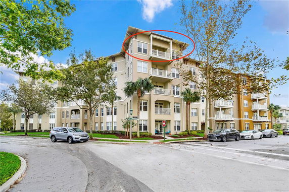 Front view of a multi-story apartment building with balconies.