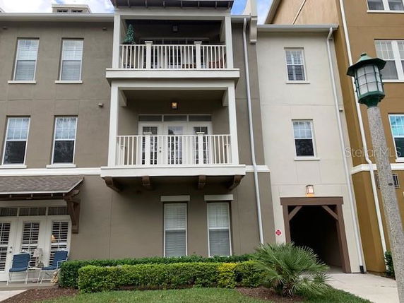 Front view of a multi-story residential building with balconies.