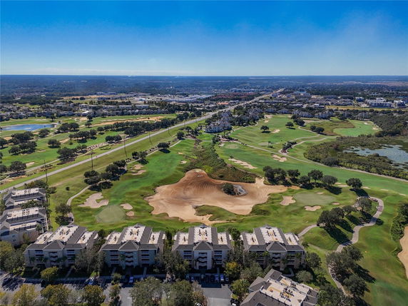 Panoramic view of surrounding areas including a golf course and residential buildings.