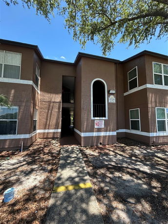 Front view of a two-story apartment building with a central entrance.