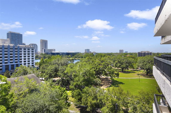 Panoramic view of cityscape with modern buildings and greenery.