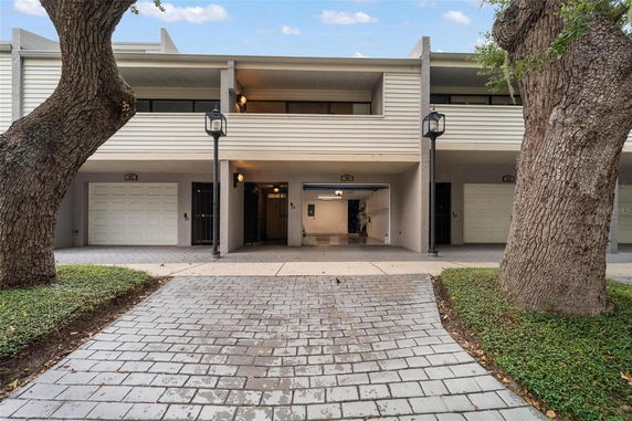 Front view of a two-story building with garages.