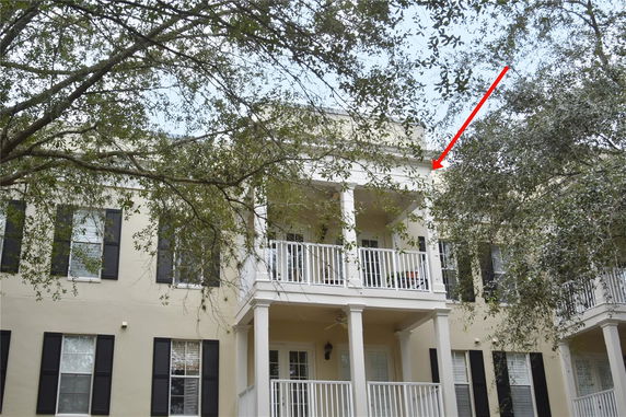 Front view of a two-story house with upper and lower balconies.