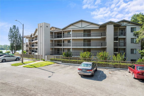 Front view of a multi-story apartment building with balconies.