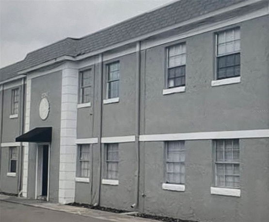 Front view of a two-story building with multiple windows and a central entrance.