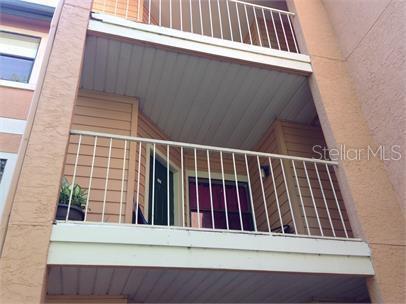 Front view of a multi-story building with balconies.