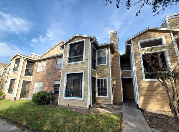 Front view of a two-story residential building with brick and siding exterior.