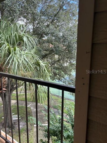 View from a balcony showing trees and a pathway.