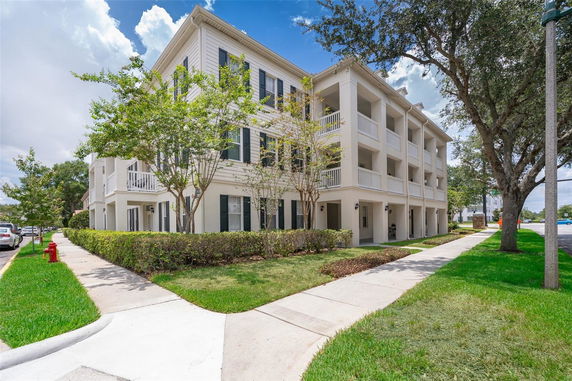 Front view of a three-story building with balconies.