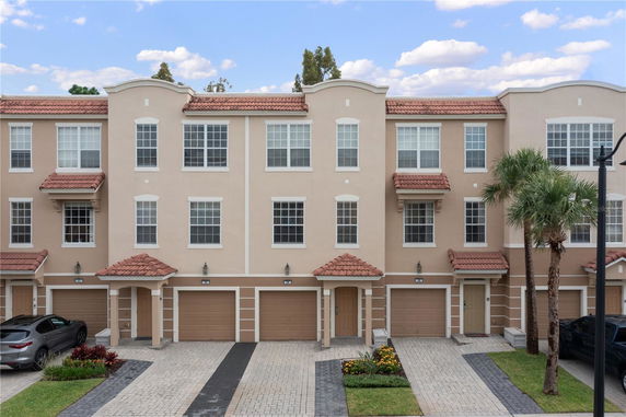 Front view of a multi-story residential building with garages.