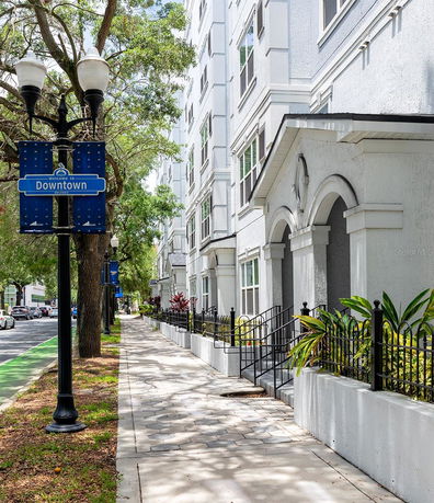 Front view of a multi-story building with decorative entrance and arched windows.