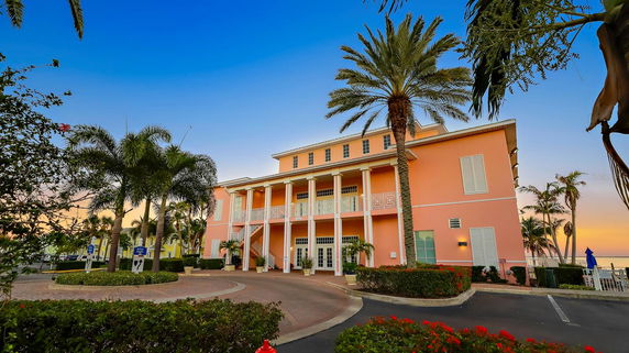 Front view of a large building with columns and a staircase.