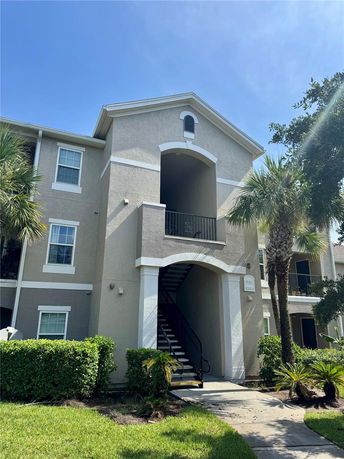 Front view of a multi-story residential building with an open stairway.