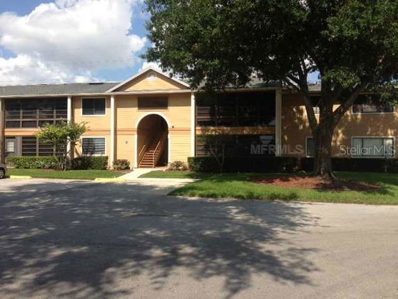 Front view of a two-story building with a central archway entrance.