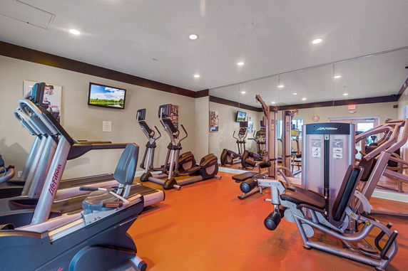 Interior view of a fitness room with various exercise equipment.