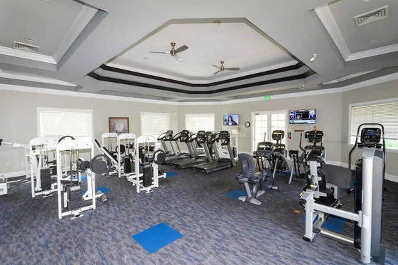 Interior view of a gym with various exercise machines.