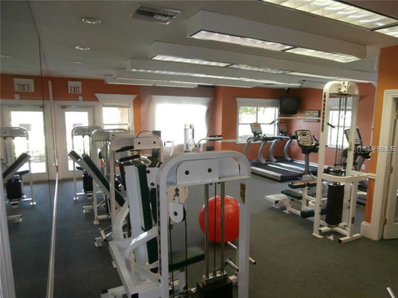 Indoor gym area with exercise machines and equipment.