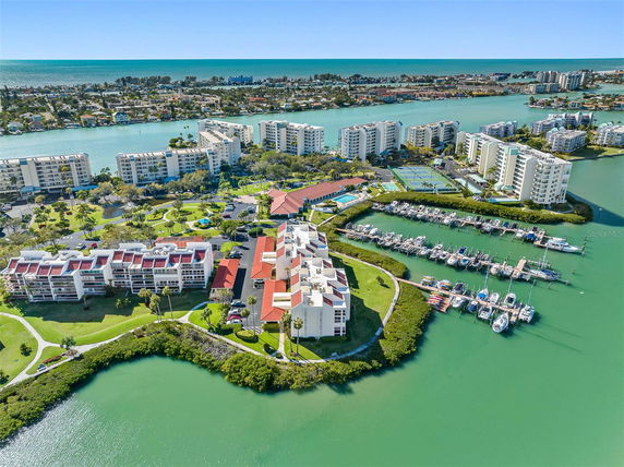 Panoramic view of a coastal area with multiple residential buildings and a marina.