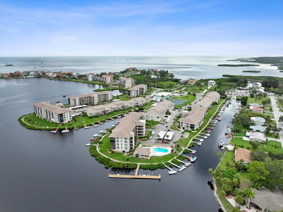 Panoramic view of residential buildings surrounded by water and green areas.