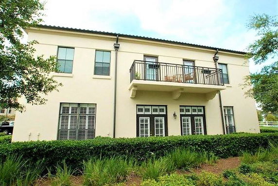 Front view of a two-story house with a balcony.