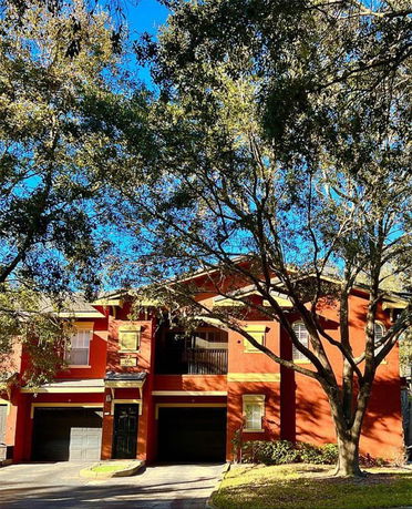 Front view of a two-story house with a double garage and balcony.
