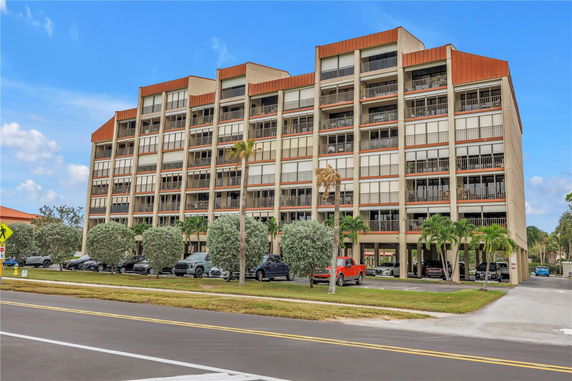 Front view of a multi-story residential building with balconies.