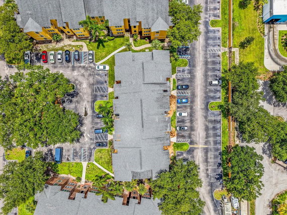 Aerial view of a large parking area around a residential building complex.
