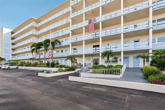 Front view of a multi-story apartment building with balconies.